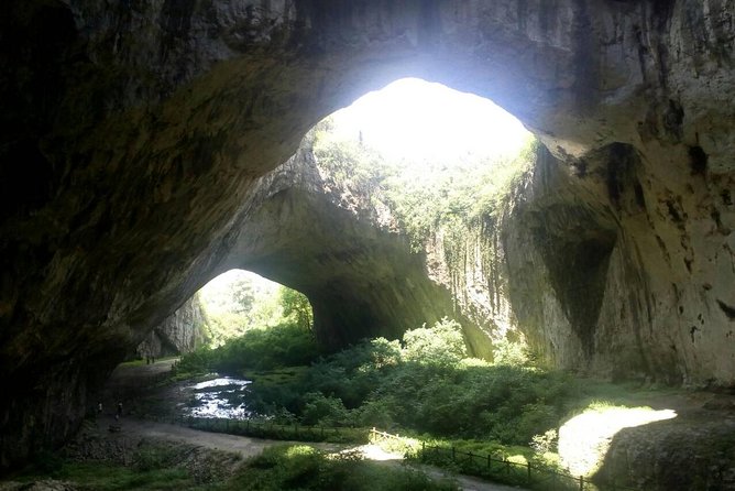 Private Day Trip to Krushuna Waterfalls and Devetashka Cave - Devetashka Cave: well lit, karst, and oddly green underfoot